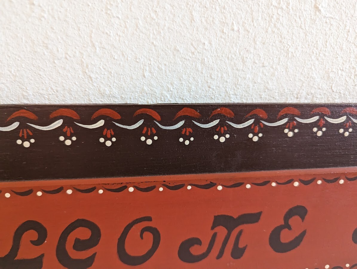 ‘Welcome All’ Folk Art Sign 24″ x 6″ Burgandy / Red Wall Hanging