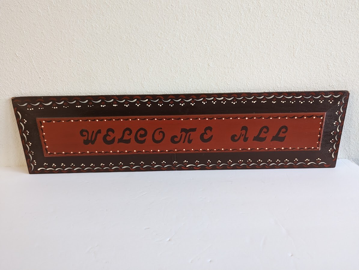 ‘Welcome All’ Folk Art Sign 24″ x 6″ Burgandy / Red Wall Hanging